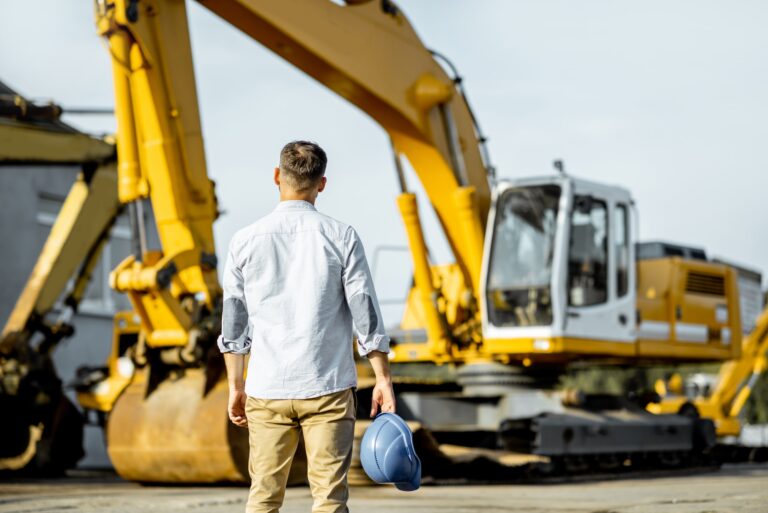 Builder at the shop with heavy machinery